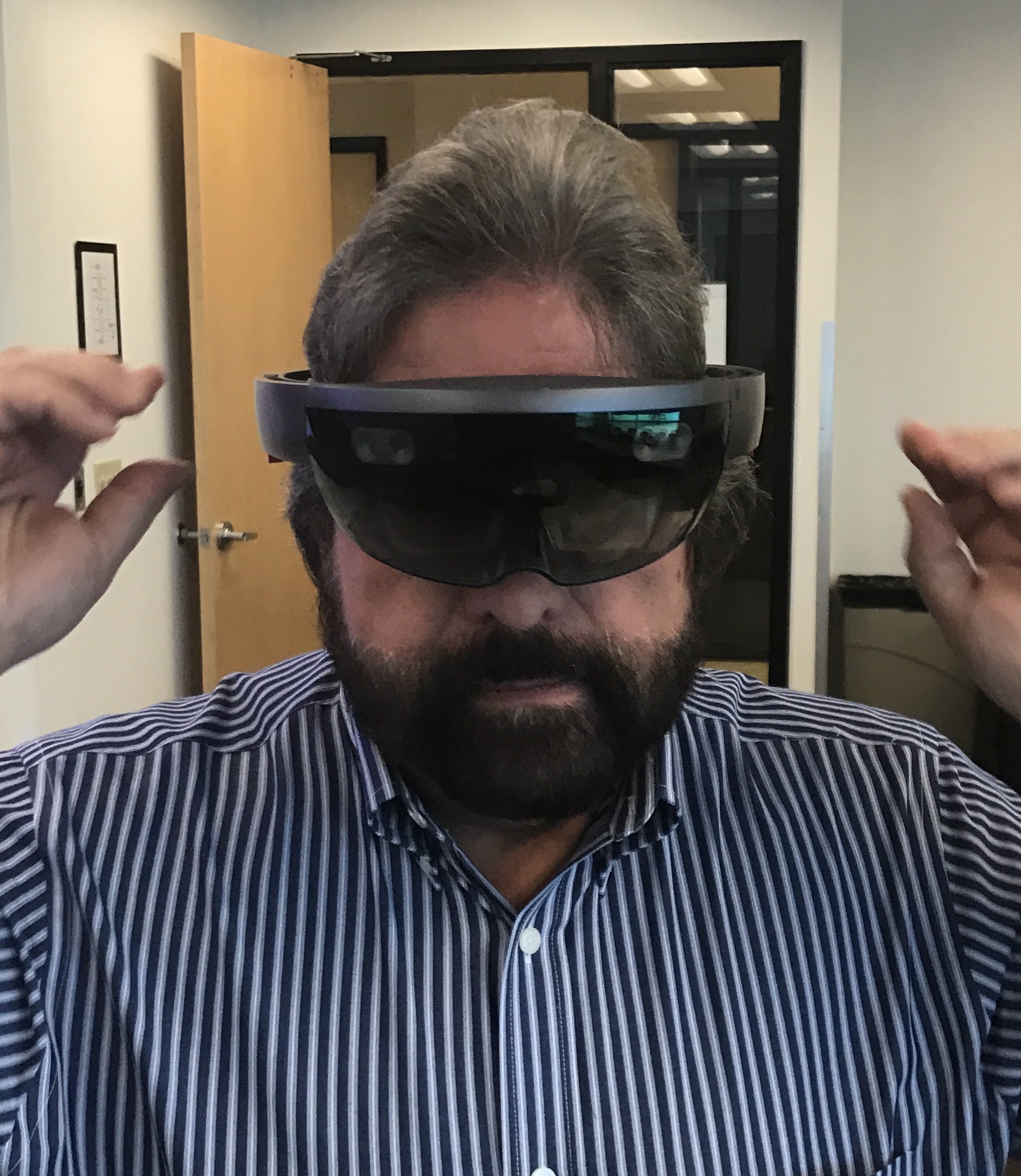 Dennis Bonilla trying on an augmented reality headset in the office