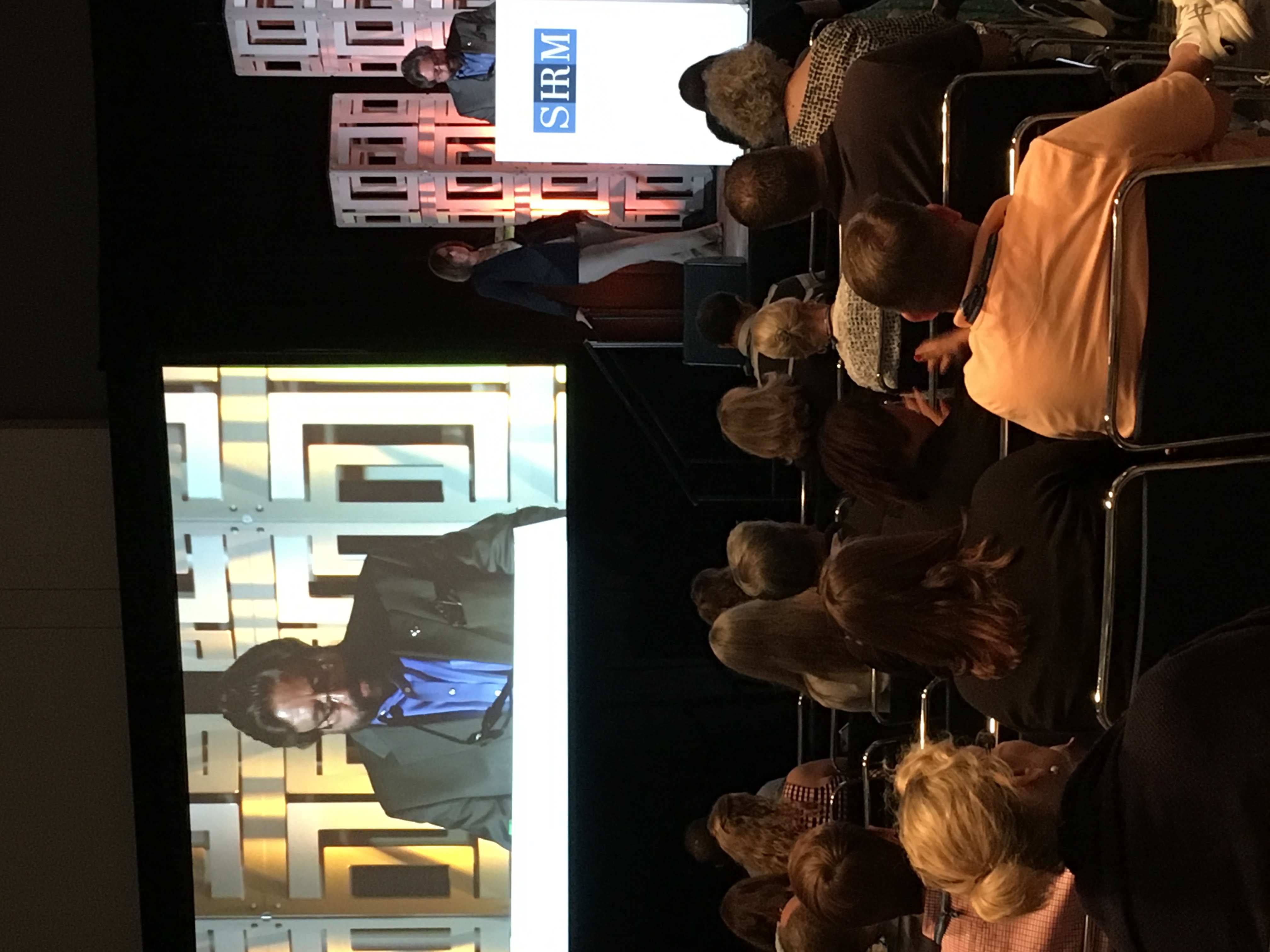 Dennis Bonilla addressing a SHRM conference audience from the stage