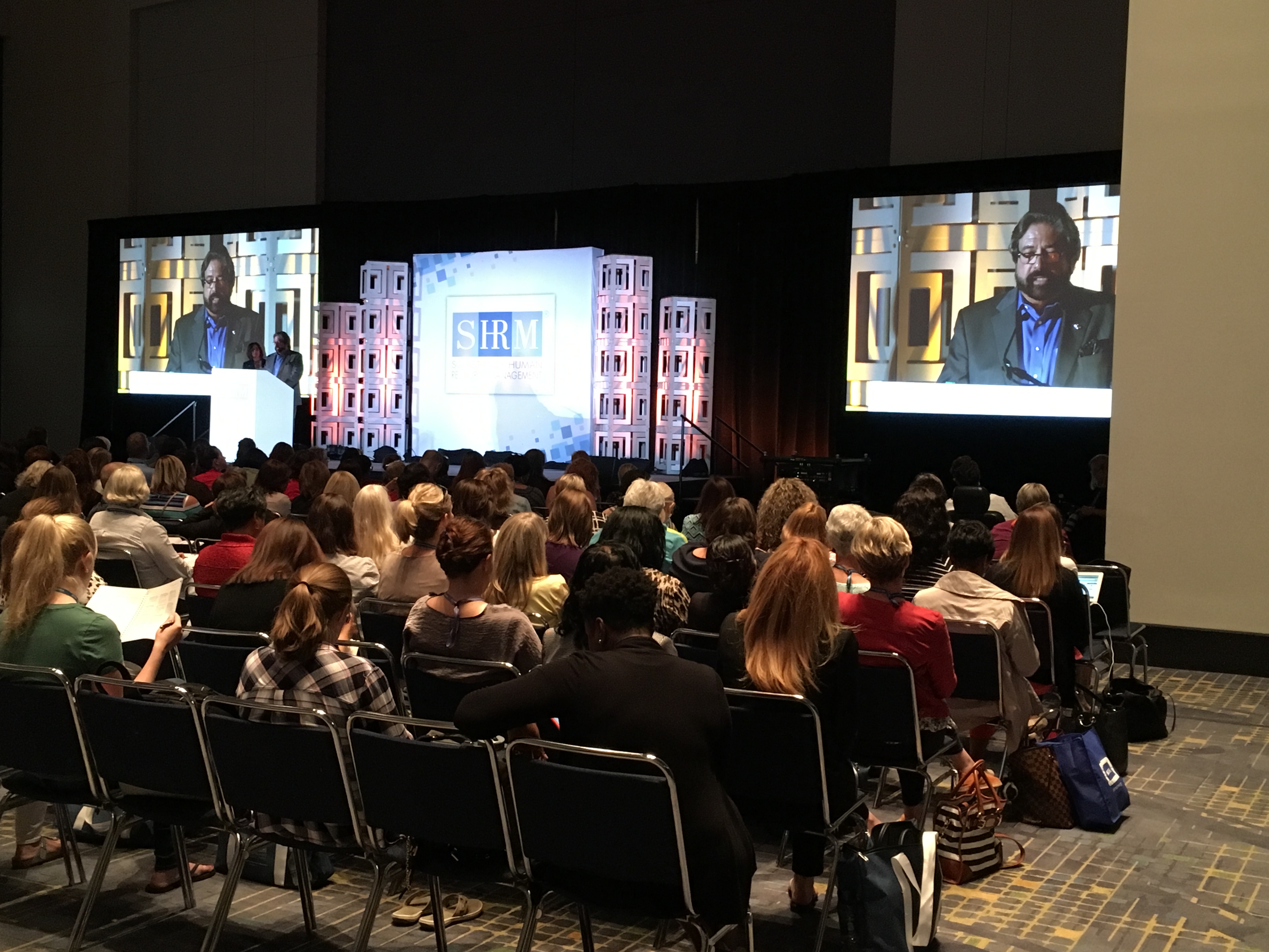 Dennis Bonilla presenting to a full ballroom at a SHRM conference