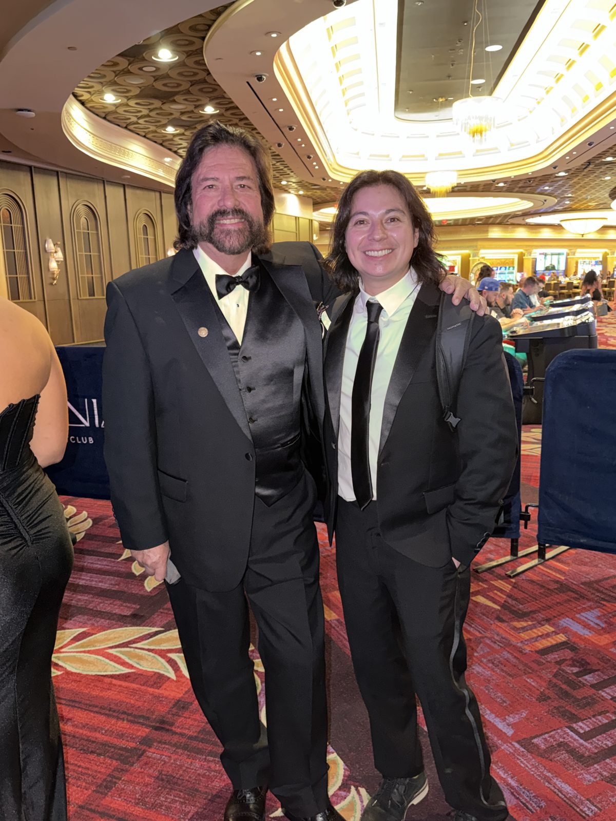 Wide view of the Aoki Gala venue with balconies, chandeliers, and dinner tables