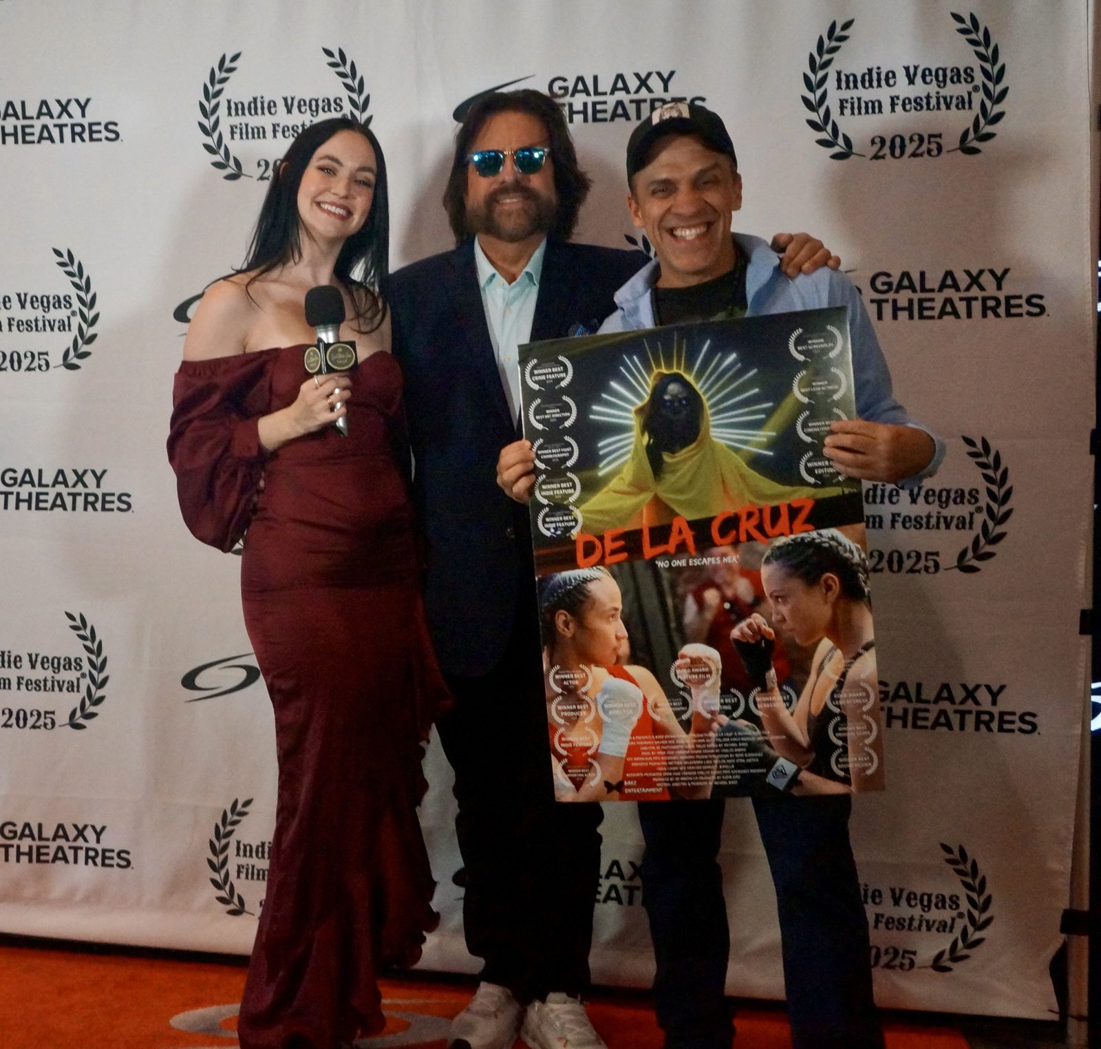 Dennis Bonilla with cast members holding the De La Cruz film poster at the 2025 Indie Vegas Film Festival